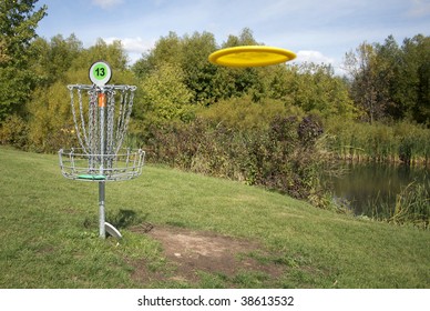 A Frisbee Golf Target With A Disc Inbound