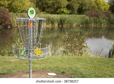 A frisbee golf target with discs in the basket.
