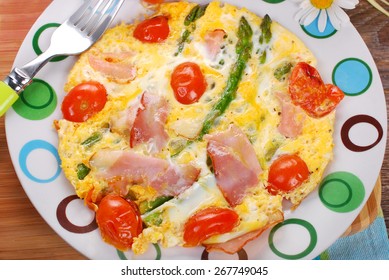 Frittata Omelet With Green Asparagus,cherry Tomato And Smoked Ham On Plate