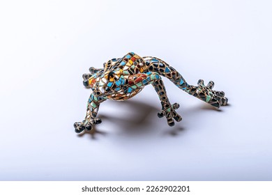 Frog figurine, decorated in the style of Gaudi from small pieces of tiles on white background. Souvenir for tourists. Toy. Barcelona, Catalonia, Spain. - Shutterstock ID 2262902201