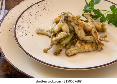 Frog Legs Cooked With Parsley On A Plate, French Cuisine