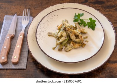 Frog Legs Cooked With Parsley On A Plate, French Cuisine