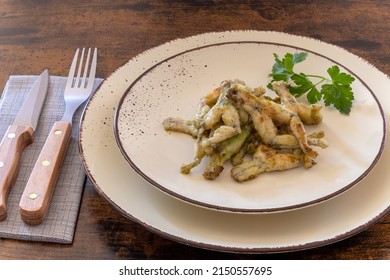 Frog Legs Cooked With Parsley On A Plate, French Cuisine