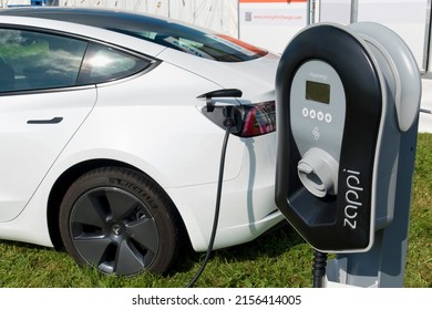 Frome, Somerset, UK - September 11 2021: A Myenergi Zappi Eco-smart Solar EV Charger Plugged Into A Tesla Model 3 Electric Car                              