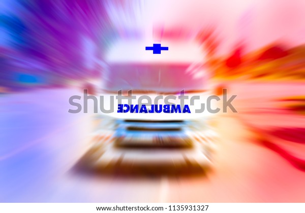 Front of Ambulance van speeding to accident\
with flashing lights,Emergency ambulance travels through city\
street,Zoom effect applied for dramatic effect, Ambulance first aid\
abstract motion blur\
shot.