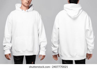 Front and back views of a man wearing a white, oversized hoodie with blank space, ideal for a mockup, set against gray background. - Powered by Shutterstock