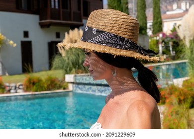 Front Behind Of A Woman Walking Along The River Of A Luxury House With Beautiful Landscaping On A Bright, Sunny Day, Modern Design.