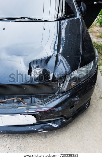 Front of black car accident bonnet damage,\
Insurance concept.