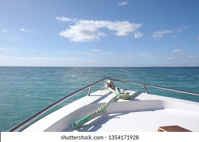 Front of a boat with the beautiful sea aand blue sky in the background.Sunny day with fluffy clouds.