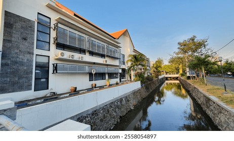 The front of the building, in front of it is a river.