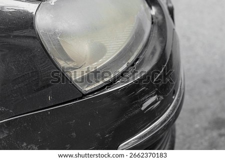 The front bumper on the right side of the black car is damaged in the form of chips, scratches, tears in plastic, paint. Insured accident event related to cars without danger to human life.