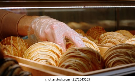 In Front Of The Camera In The Coffee Shop Barista Man Taking From The Showcase Fridge Some Fresh Baked Croissants