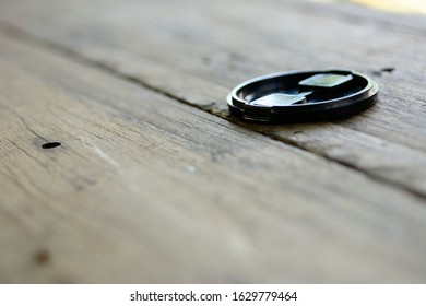 front cap camera was placed on a wooden texture table, selective blur background