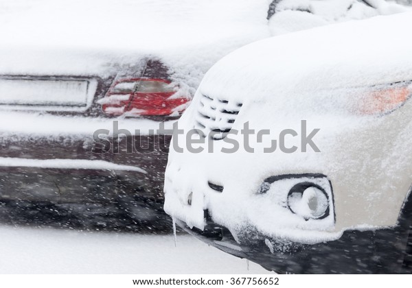 The\
front of the car - the bonnet, under a layer of\
snow