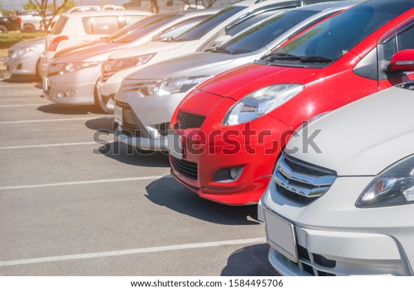 Front car parking in outdoor\
parking lot in a row. Travel transportation modern technology\
concept\
