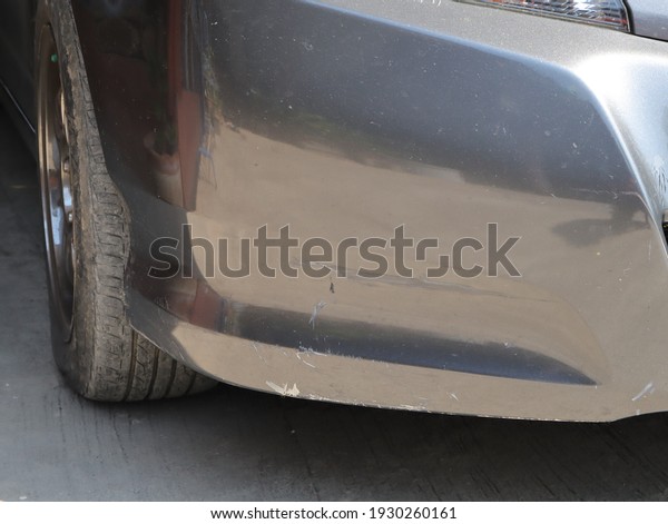 In the front of the car  With scratch marks \
Causing abrasions of the car\'s\
paint