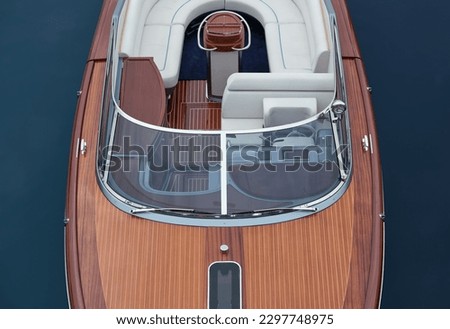Front deck Luxurious lacquered wooden big boat on the water top view. Large expensive varnished wooden boat top view
