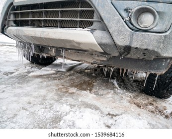 Front Dirty Bumper Of The Car With Icicles, Bottom View. Snow, Winter, Car, Icicles.