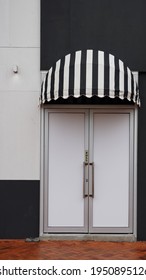 Front Door With Black And White Striped Canvas Awning