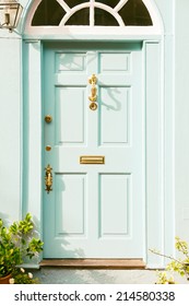 Front Door Of A Cottage With Vintage Brass Hardware