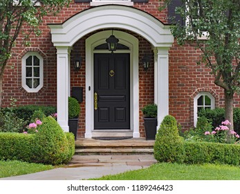 front door with curved portico roof