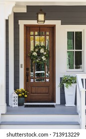 Front door with a decorative wreath 