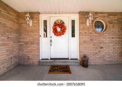 Front door exterior with maple leaves wreath and two side panels