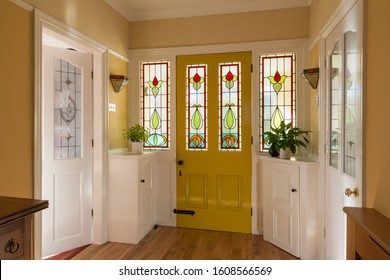 Front Door And Hallway Of A House In England With Stained Glass Window In The Door.