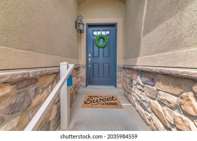 Front Door Of A House With Glass Panel, Wreath And A Home Sweet Home Doormat