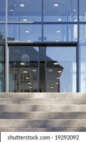 The Front Door Of A Office Block, Reflecting  Buildings In The Glass