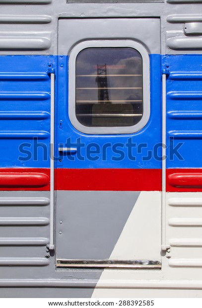 front door\
in an old passenger wagon with red\
stripe