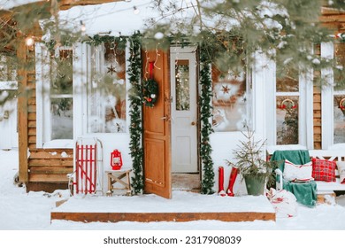 front door porch of village countryside house with swing hammock decorated for Christmas winter holidays, Christmas and New year vacation concept