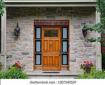 front door of stone house with wooden door and lion head knocker