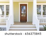 Front door, front view an inviting house with a porch