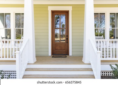 Front door, front view an inviting house with a porch - Shutterstock ID 656375845