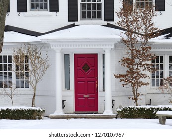 Front Door Of White Painted Brick House With Snow