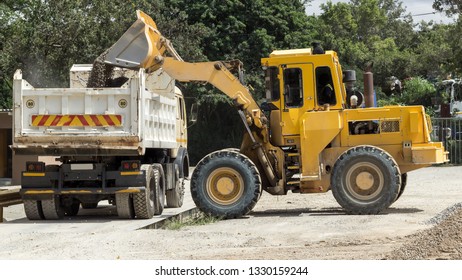 Front End Loader Loading A Dump Truck On A Weigh Bridge