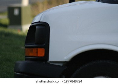 Front End Of White Van, Headlights, And Tail Lights.