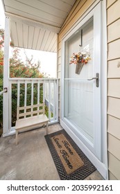 Front Entrance Of A House With Glass Storm Door And Home Sweet Home Doormat