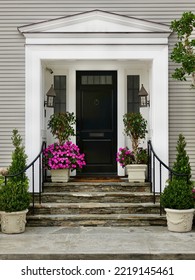   Front Entry Of Contemporary Home With Flagstone Stoop And Wrought Iron Railing                             