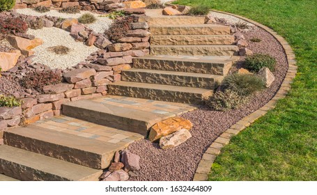 Front garden rockery with outside staircase made of sandstone and concrete pavement