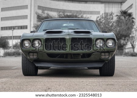 The front of a green American muscle car