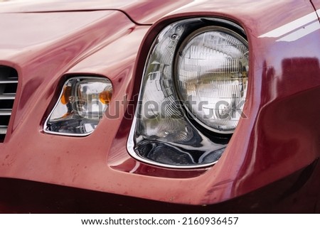front headlight is a close-up of an old powerful classic American car