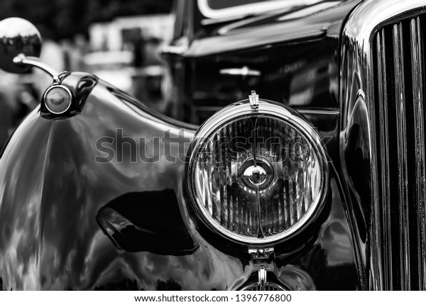 The front\
headlight on a luxury vintage\
car.