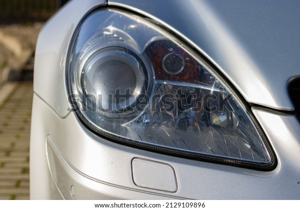 Front Headlight View of Sport Car. Gray Sport Car in the\
Street 