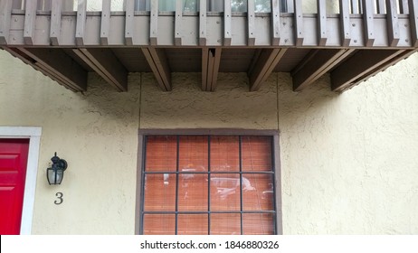 The Front Of A House With An Overhanging Porch. Wood Under The Porch Shows Damage Caused By Carpenter Ants.