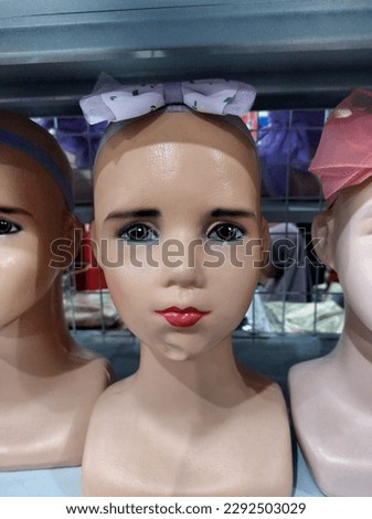 front image of shiny white female mannequin doll. front image of a display dummy figures. Front image of a mannequin display wearing makeup