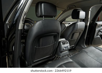 front leather car seat backs view from the back row. adjustment of the climatic system and air supply deflectors of the second row ventilation system. head restraints - Shutterstock ID 2266492119