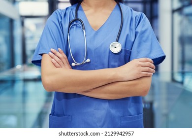 The Front Line Of Healthcare. Portrait Of A Young Female Doctor Standing With Her Arms Crossed In A Hospital.