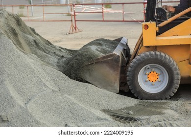 Front loader loading sand close-up, detail